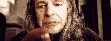 John Noble as Denethor stuffing chicken into his mouth with his hands