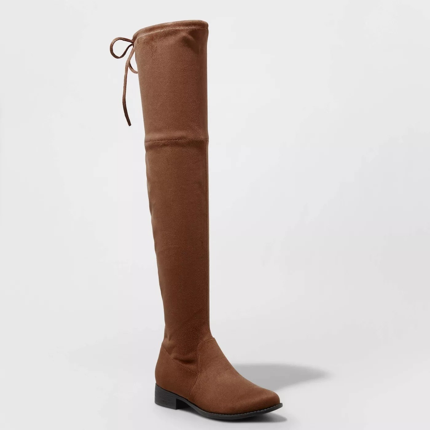 brown colored boots with black sole, tie string detail at the top of the boot