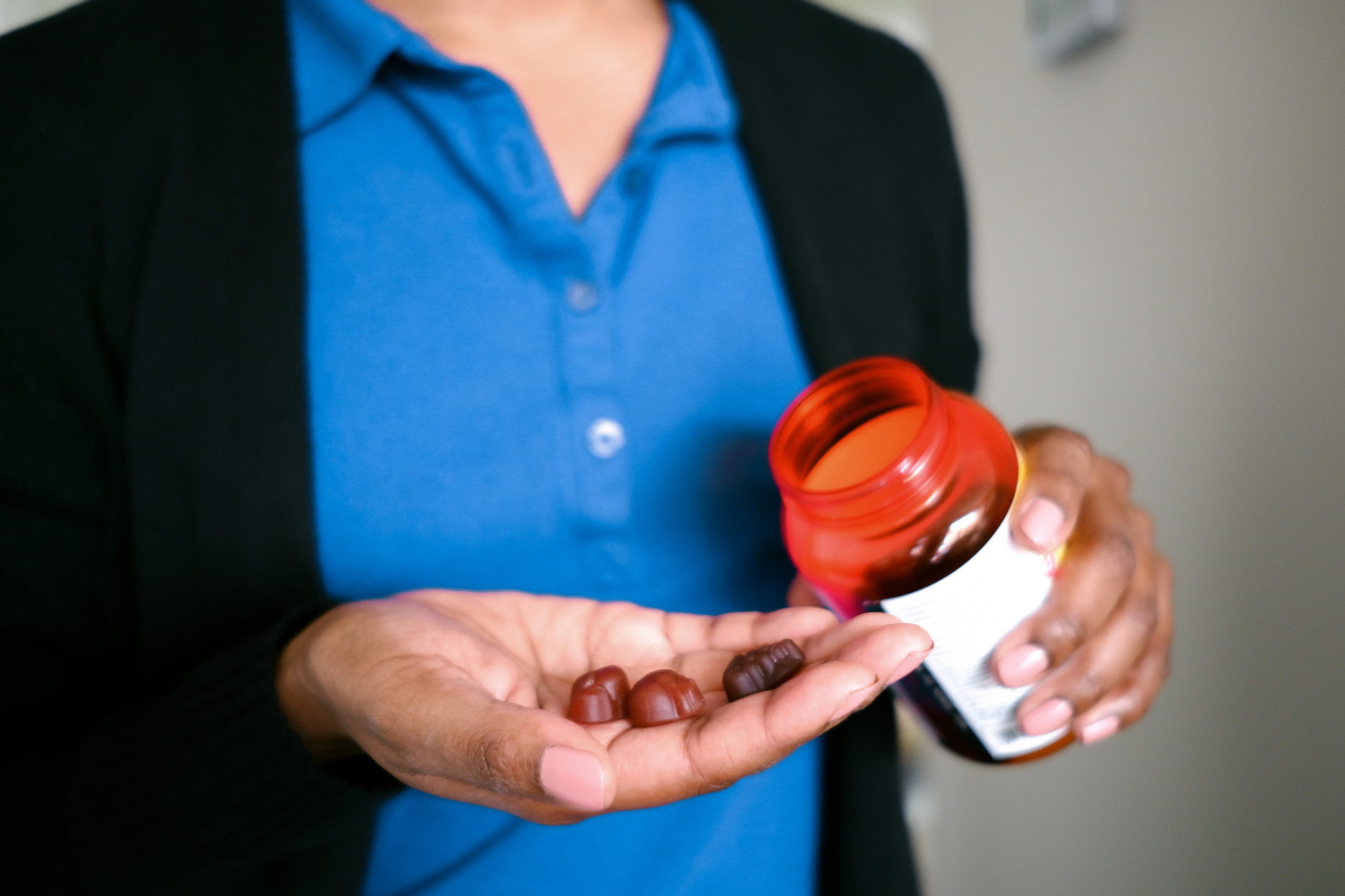 Someone pouring gummy vitamins into their hand