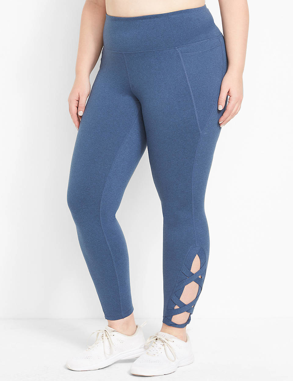 Model is wearing pale blue leggings with a criss cross cut out near the ankles