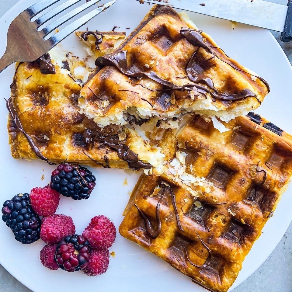 Waffles with berries on the side.