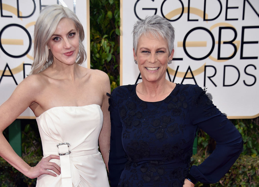 Mother and daughter are standing with their hands on their hips at the Golden Globes