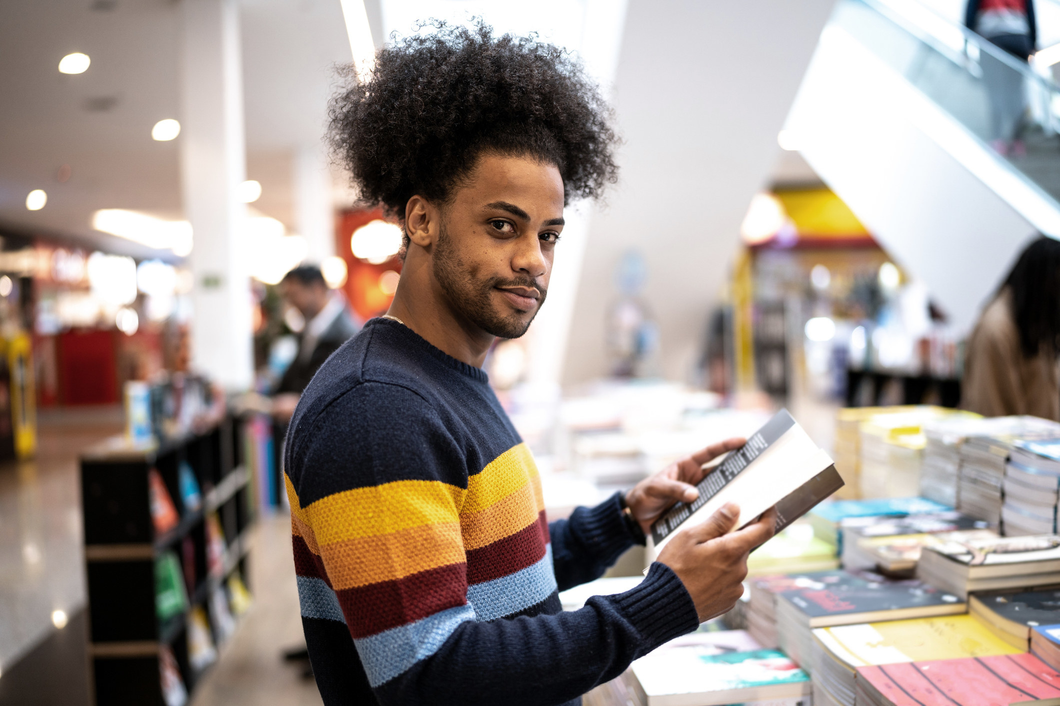 Portrait of a young man in a bookstore at the mall