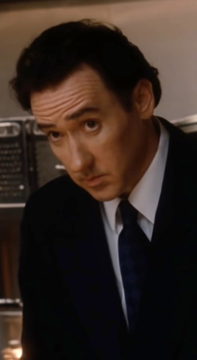 Cusack as Nixon, in the White House kitchen