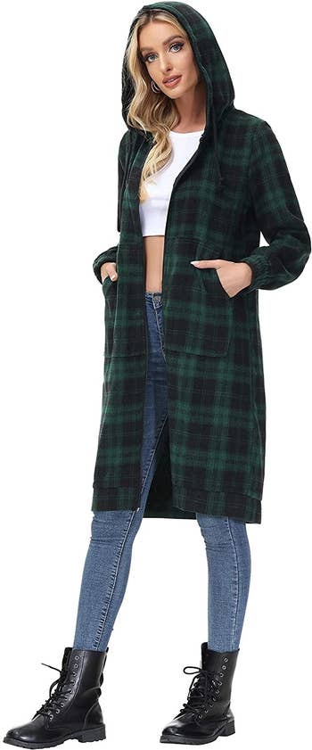 model wearing the green plaid long sweatshirt with the hood up