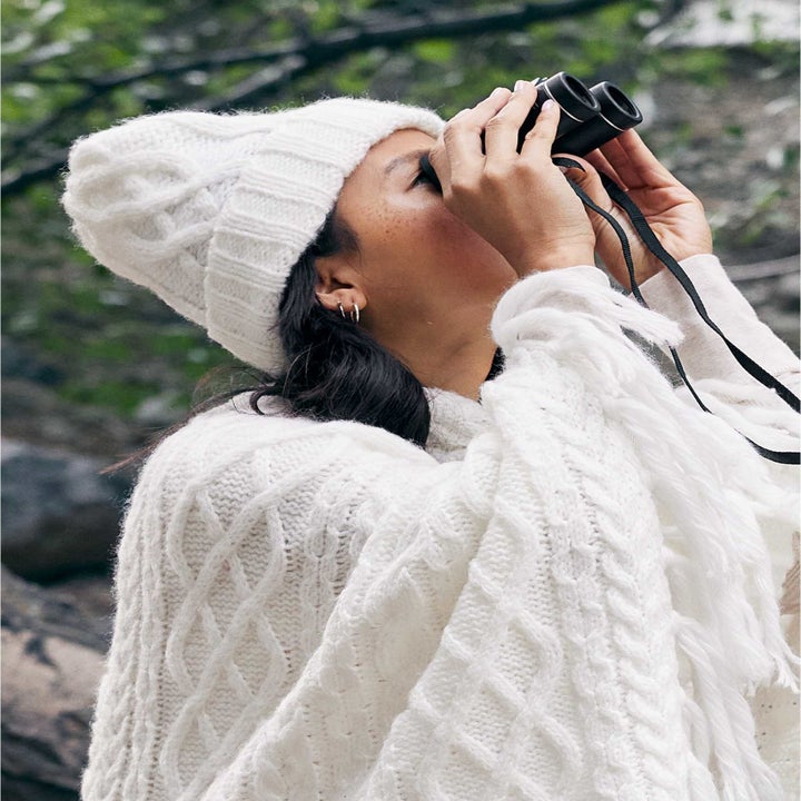 model wearing white cable beanie and matching sweater