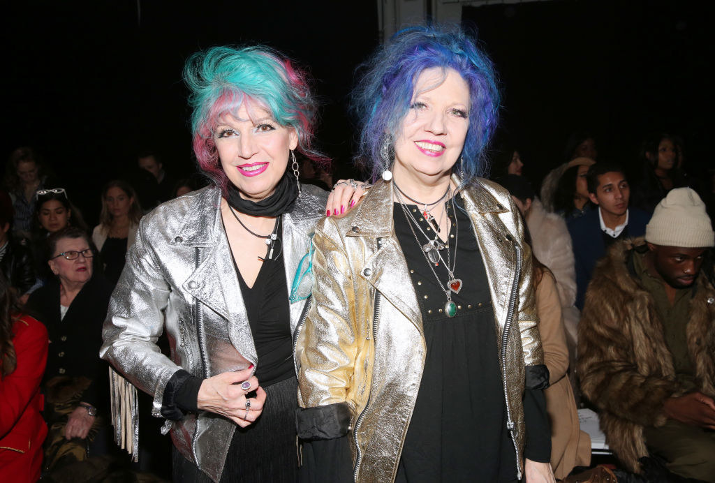 Two older women with colorful hair posing next to each other