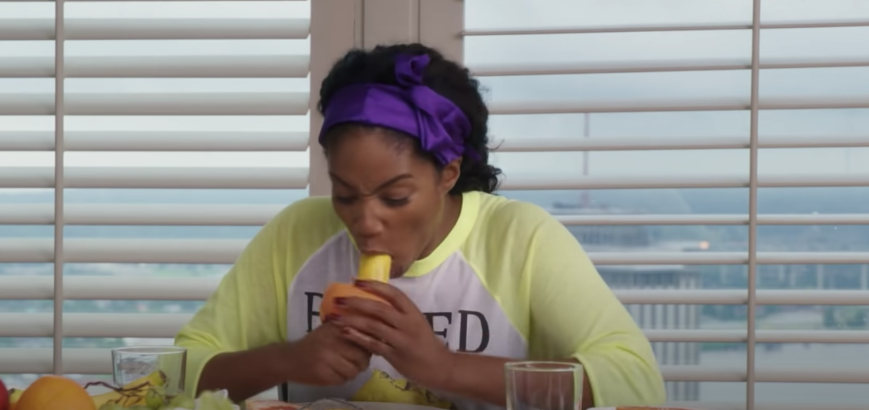 Tiffany Haddish with fruit in her mouth
