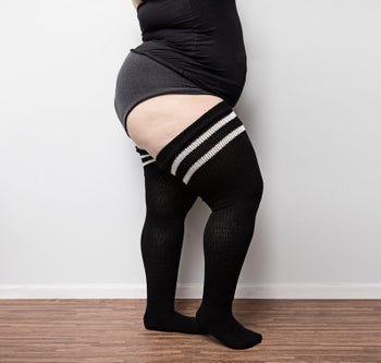 Model wearing black socks with white stripes