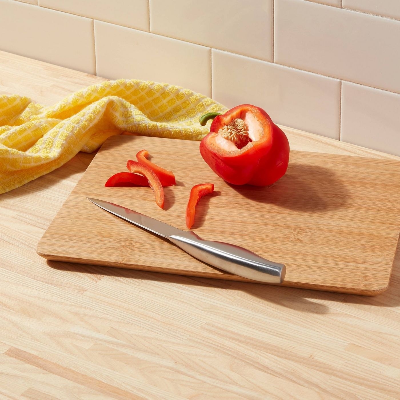 The cutting board with a sliced red pepper on it