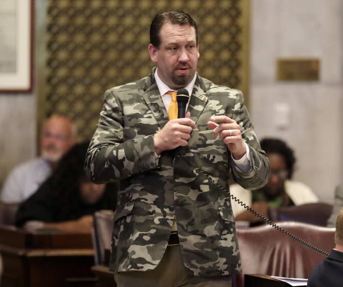 Faison wearing a camouflage print blazer in a House session