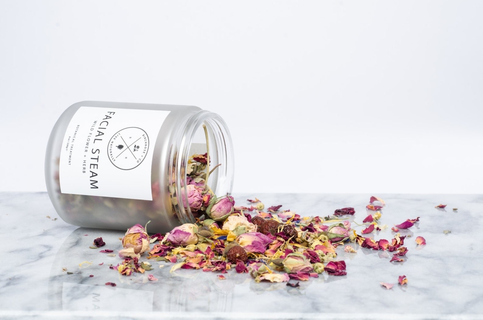 A jar of the facial steam knocked over with all the dried flowers spilled over