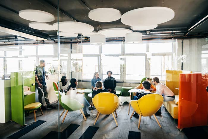 People seated at tables at work