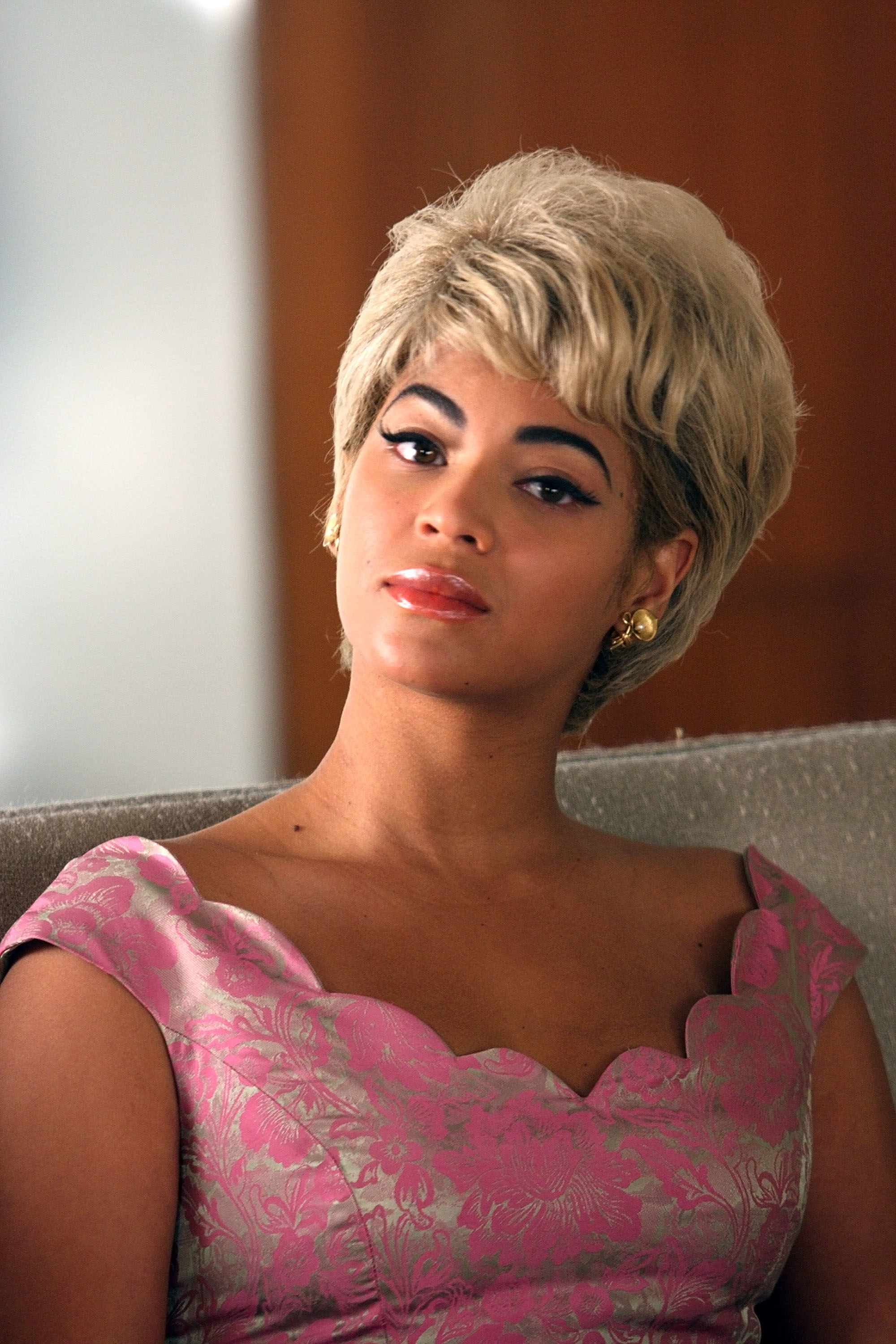 Beyoncé sitting in a chair with short, blonde hair