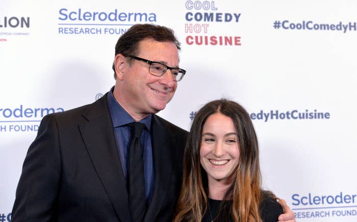 Bob Saget posing for a photo at a red carpet event with his arm around his daughter&#x27;s shoulders