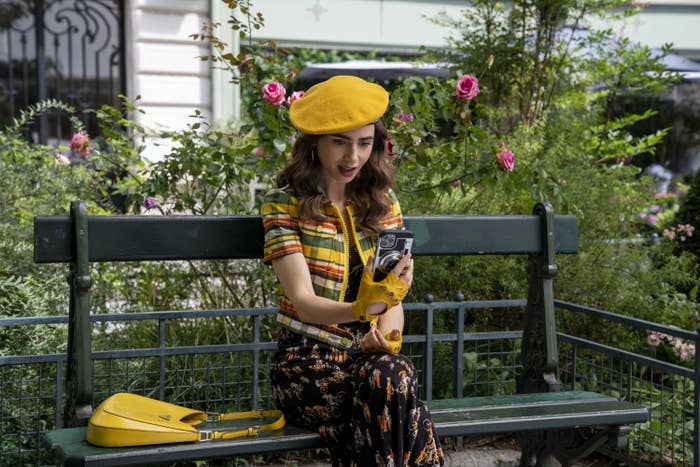 Emily wearing a colorful beret and sitting on a bench