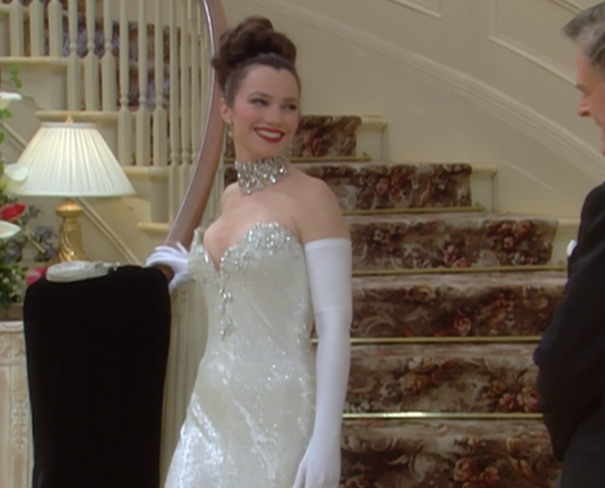 Fran walking down the staircase in jeweled gown