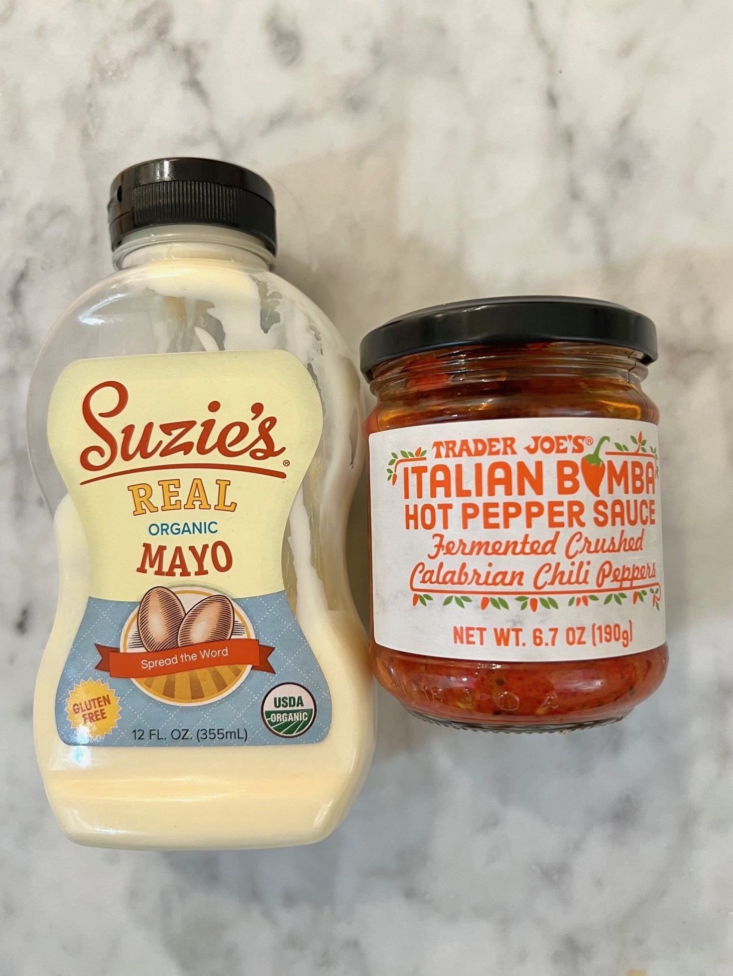 Mayo and Italian Bomba sauce on a countertop.