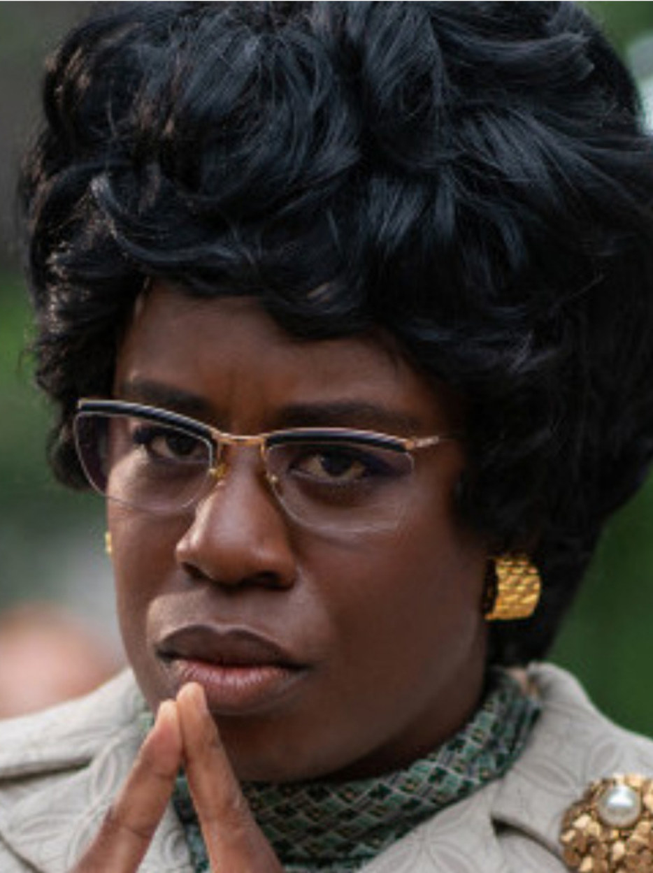 Aduba wearing glasses while thinking pensively