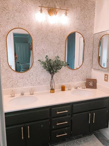 different reviewer's bathroom with black cabinets and gold pulls installed on drawers and cabinets