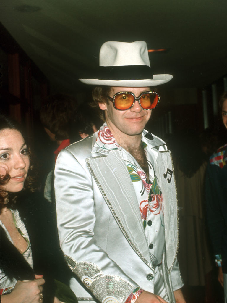 John wearing a suit and cowboy hat in 1977