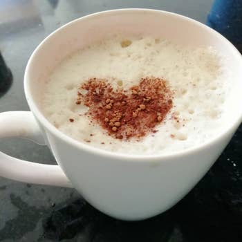 a reviewer photo of a white mug with a foamy top layer