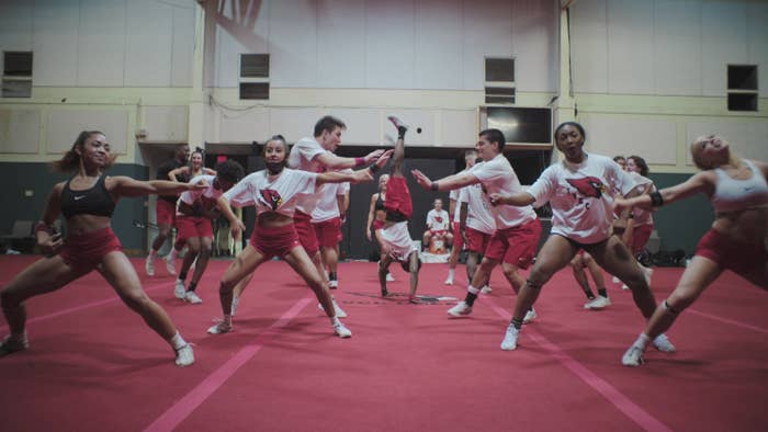 Cheerleaders perform a routine on the mat
