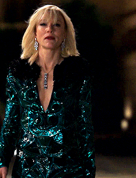 Lou walking the streets in a bejeweled suit