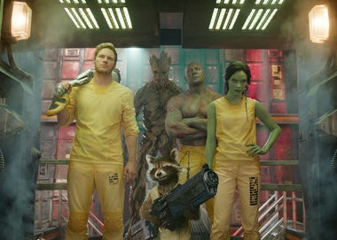 Quill, Groot, Rocket, Drax, and Gamora wearing jail uniforms