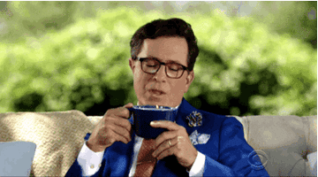 Stephen Colbert sits on a couch and blows steam off of a mug of liquid before inhaling it in &quot;The Late Show with Stephen Colbert&quot;