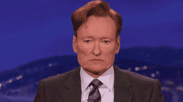 Conan O'Brien stares into the camera as it zooms in on his expressionless face in