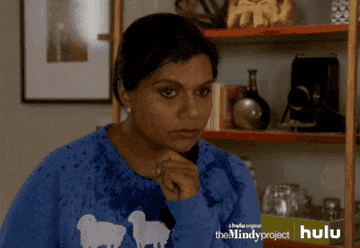 Mindy Kaling as Dr. Mindy Kuhel Lahiri squints her eyes and frowns before looking away for a moment in