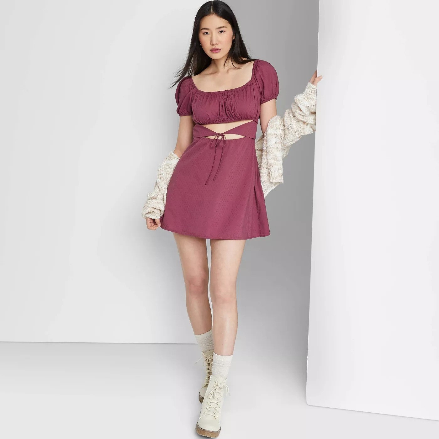 Model wearing mauve mini dress, stops above the thigh