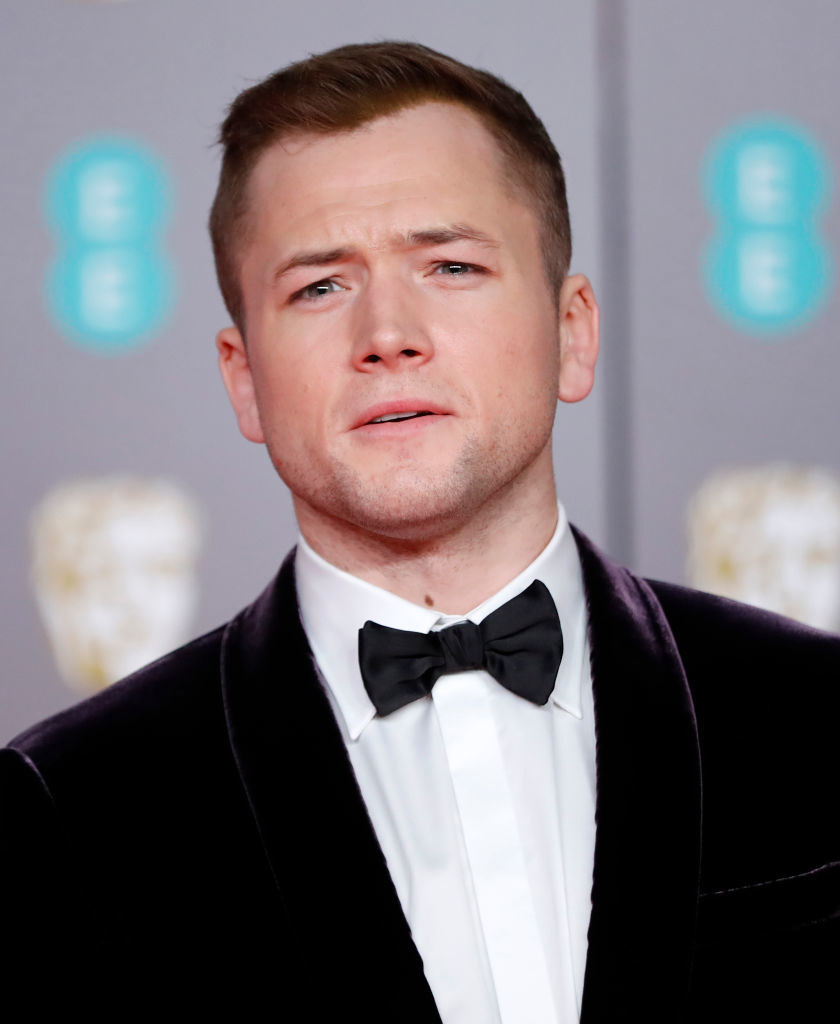 Taron Egerton poses on the red carpet upon arrival at the BAFTA British Academy Film Awards