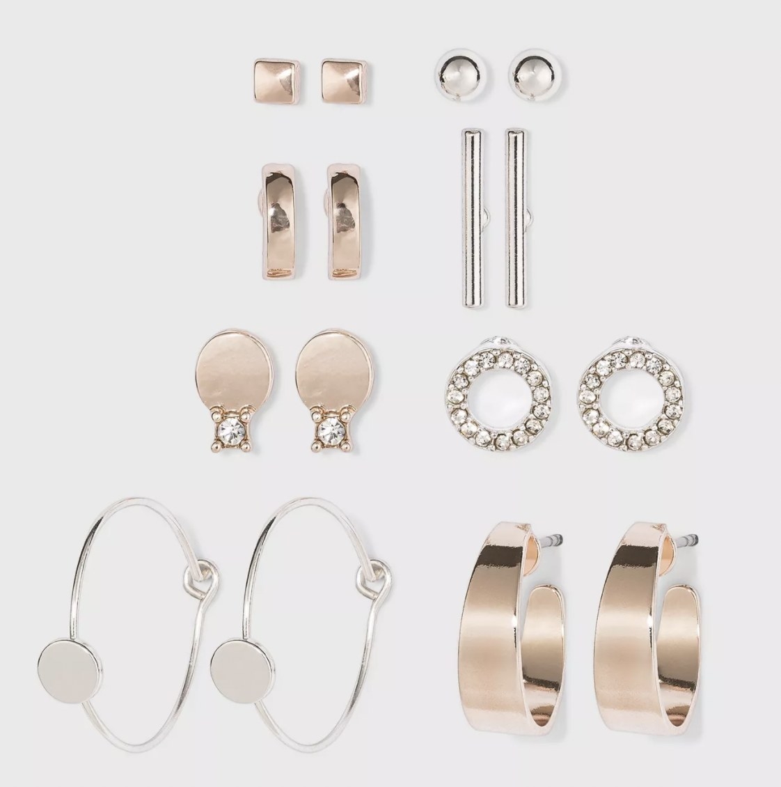 the full set if silver and rose gold stud and hoop earrings