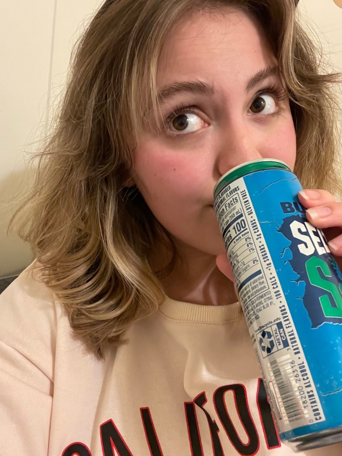 woman sipping a seltzer