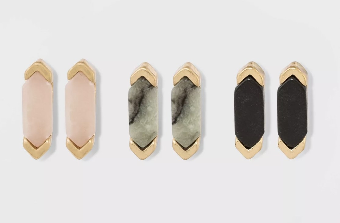 three geometric stud earrings with pink, grey, and black stones