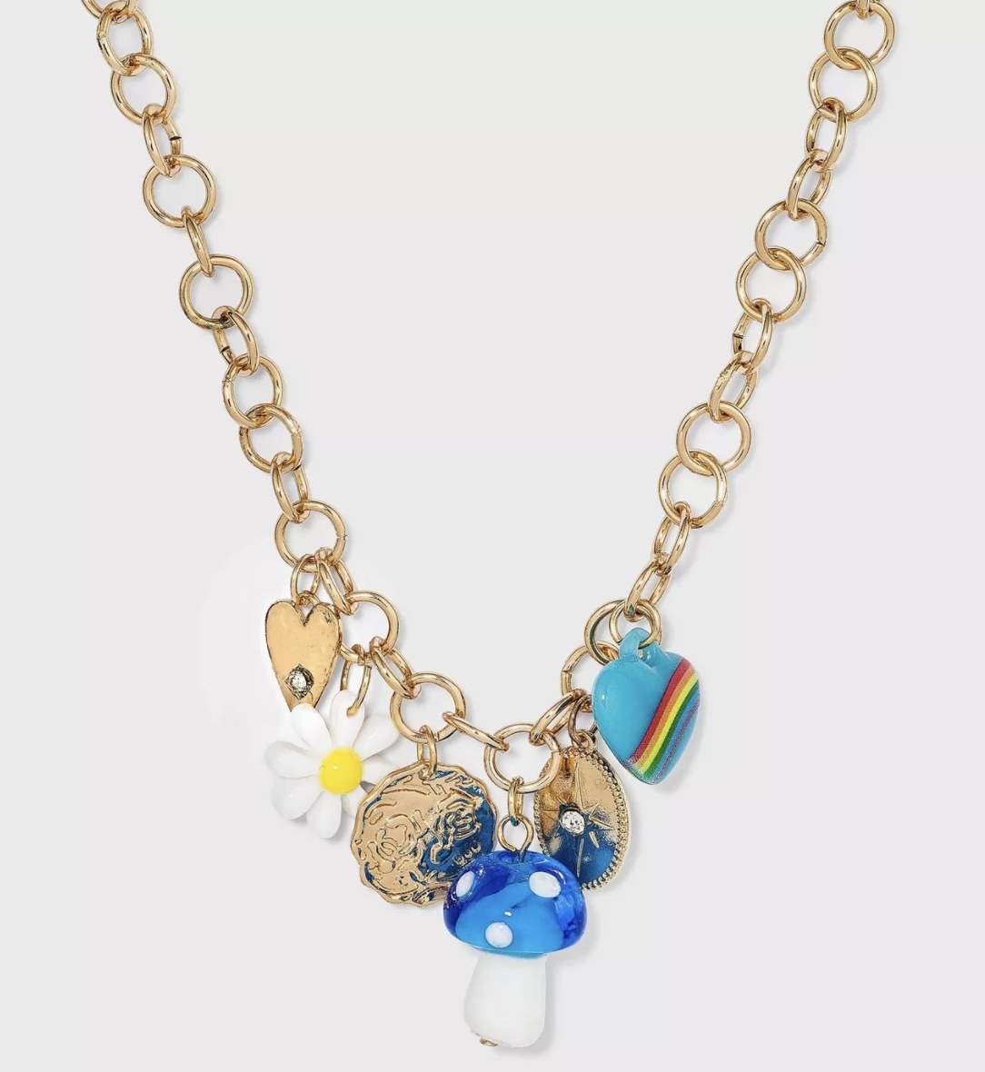 a gold chain with blue hearts and mushroom charms, a white and yellow daisy charm, and gold pendants and a gold heart charm
