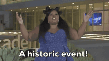 Nicole Byer saying &quot;A historic event!&quot; as she raises her arms