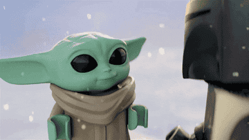 GIF of Lego baby yoda bouncing around in the snow