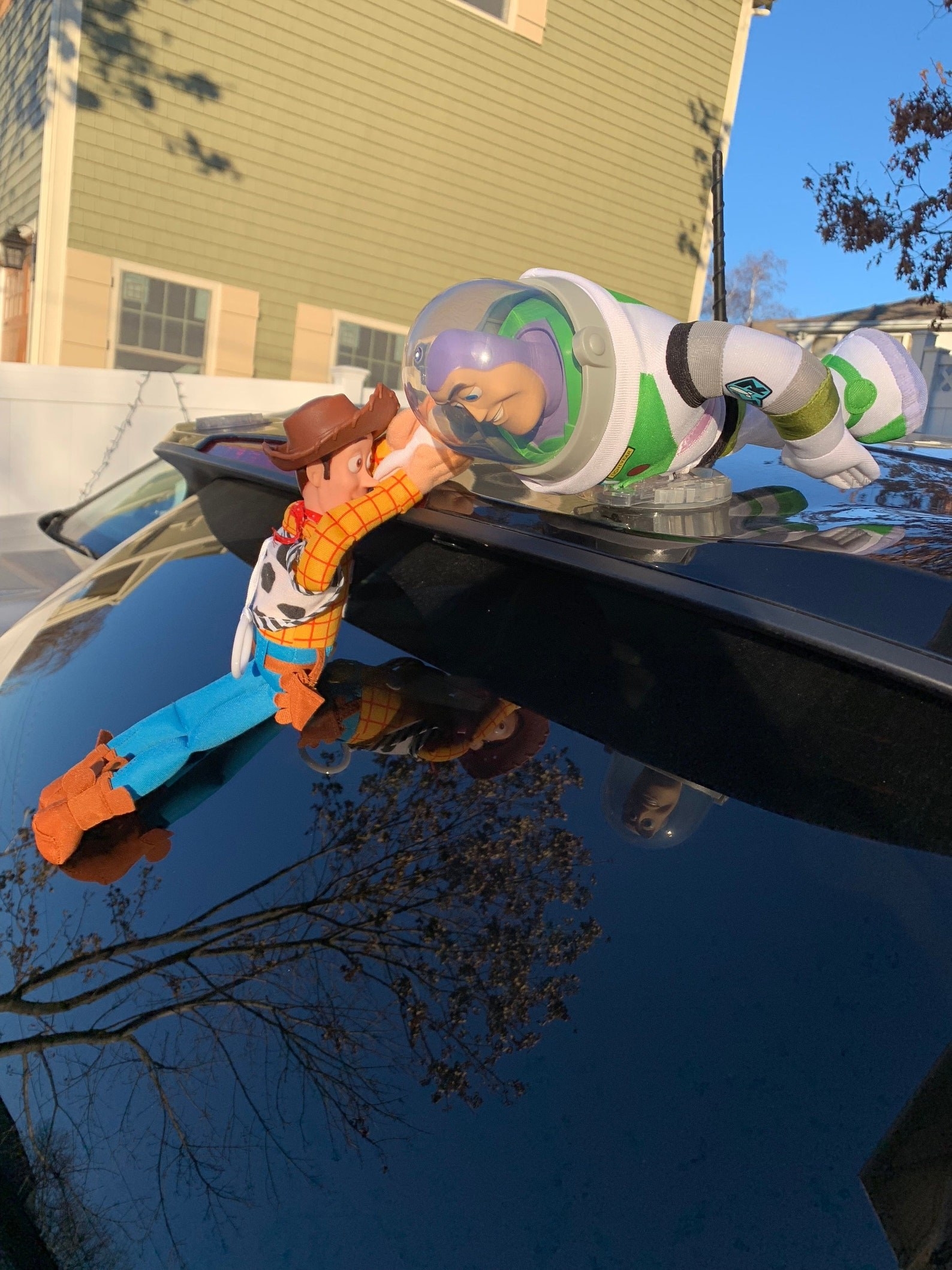The ToyStory accessory of Buzz Lightyear saving Woody from dangling on the edge of a car