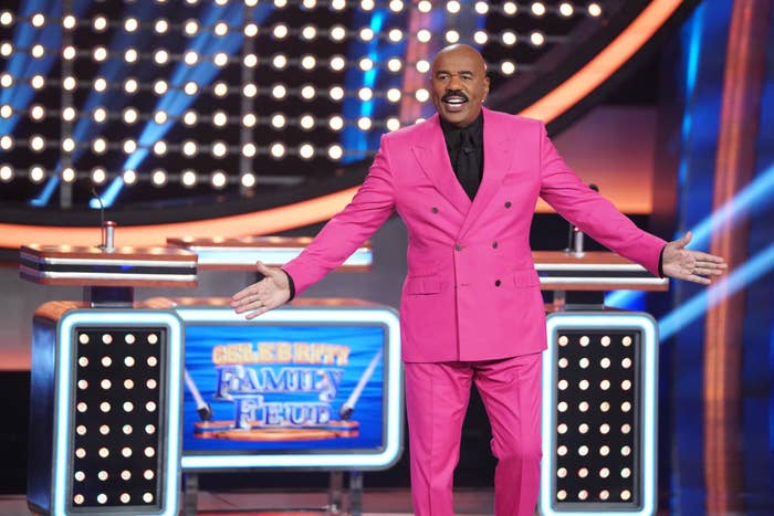 Steve Harvey smiling onstage of his show Celebrity Family Feud