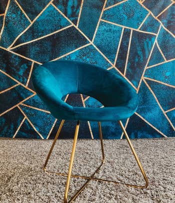 reviewer photo of the blue velvet chair with gold legs