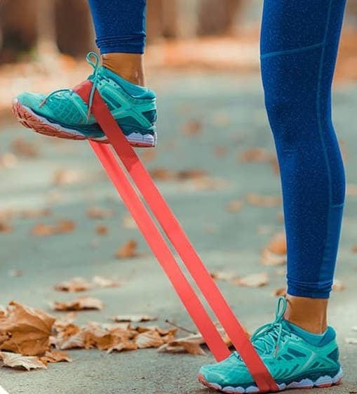 A person stretching with an elastic band.