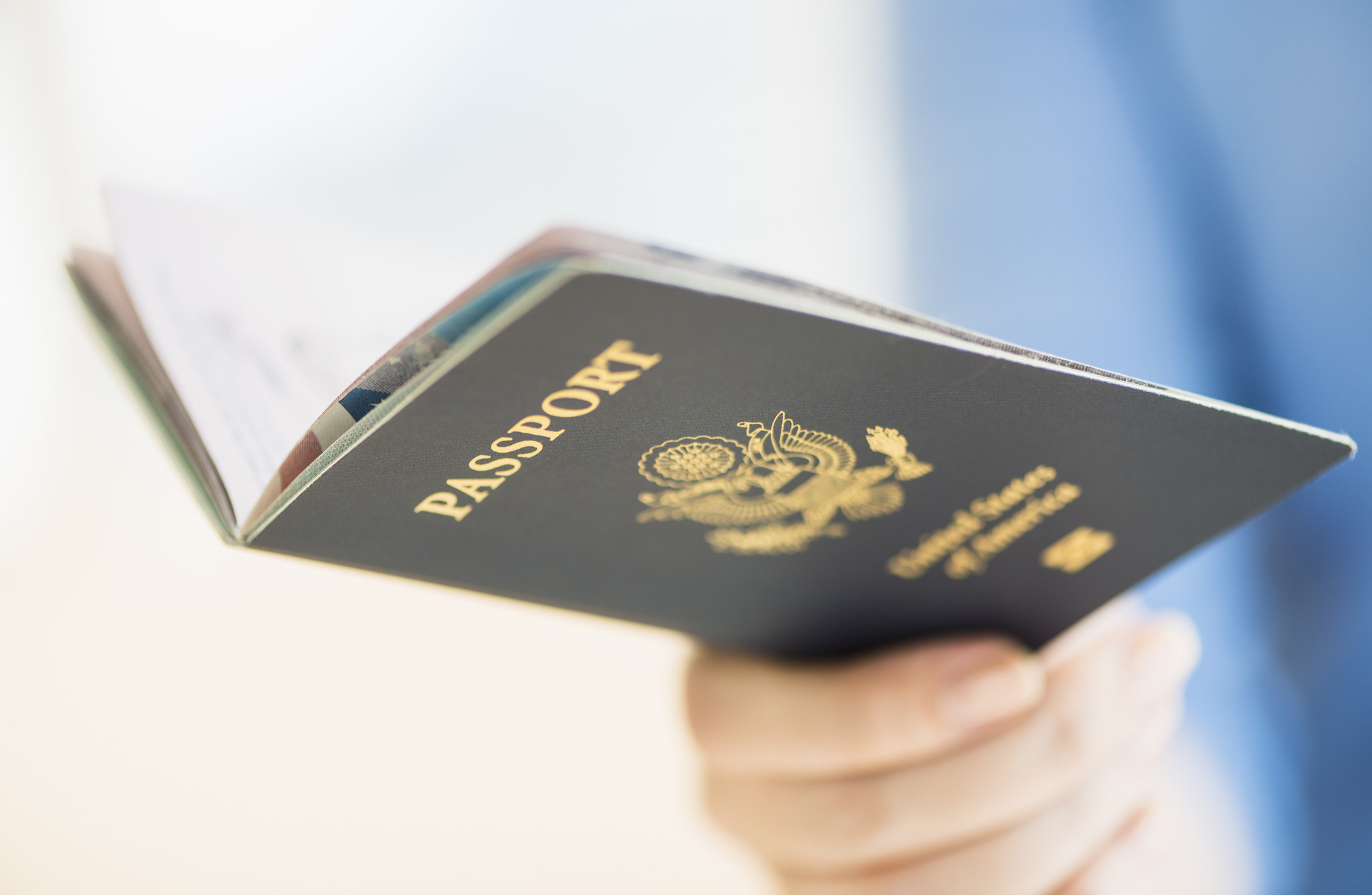 A woman holding a US passport.
