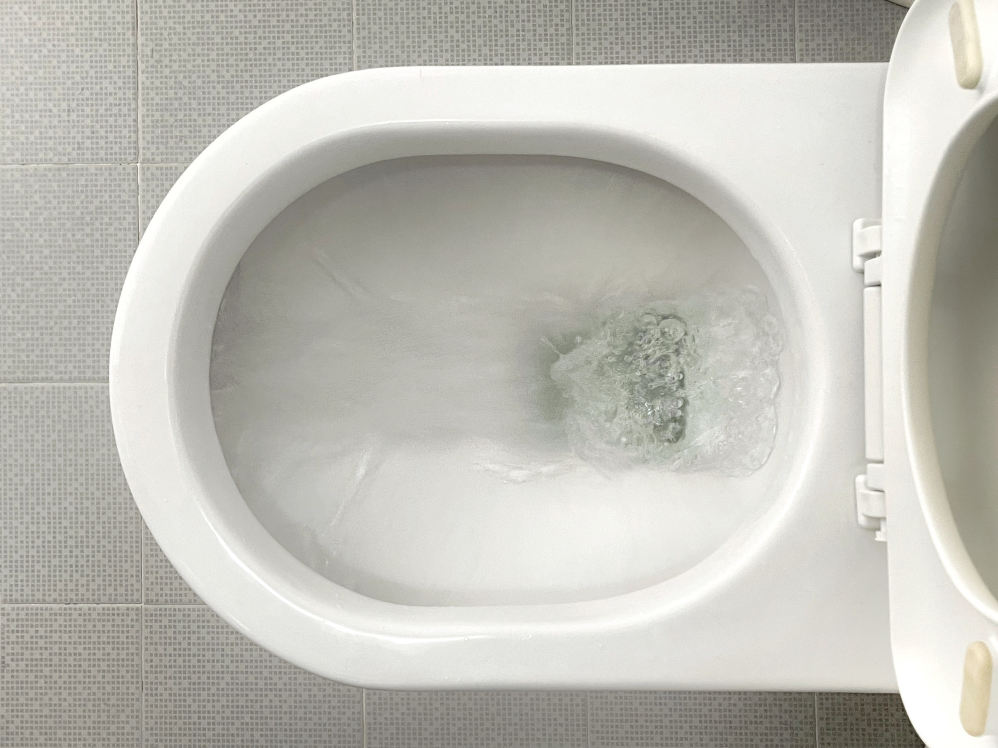 A toilet flushing.