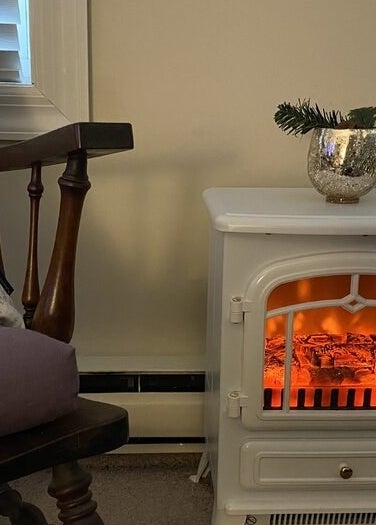 A white fake fireplace in a home