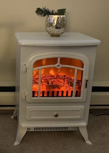 A white fake fireplace in a home