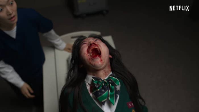 A girl transforms into a zombie while a nurse looks at her