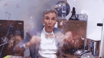 Bill Nye sitting at his desk and doing the &quot;mind blown&quot; hand motion away from his head
